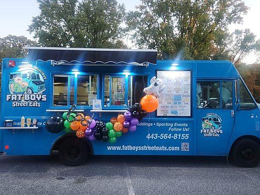 Fat Boys Street Eats truck lit up at an evening event