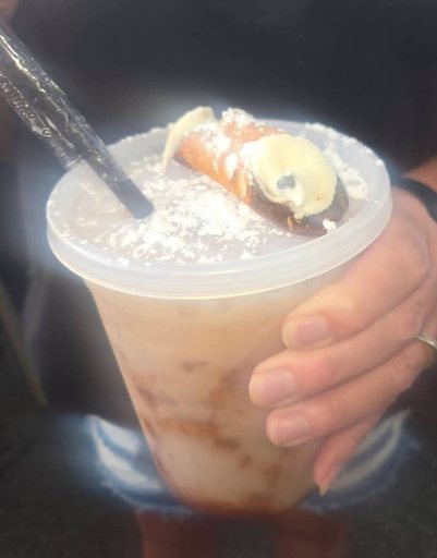 Iced coffee from the Fat Boys truck, topped with a mini cannoli and powdered sugar